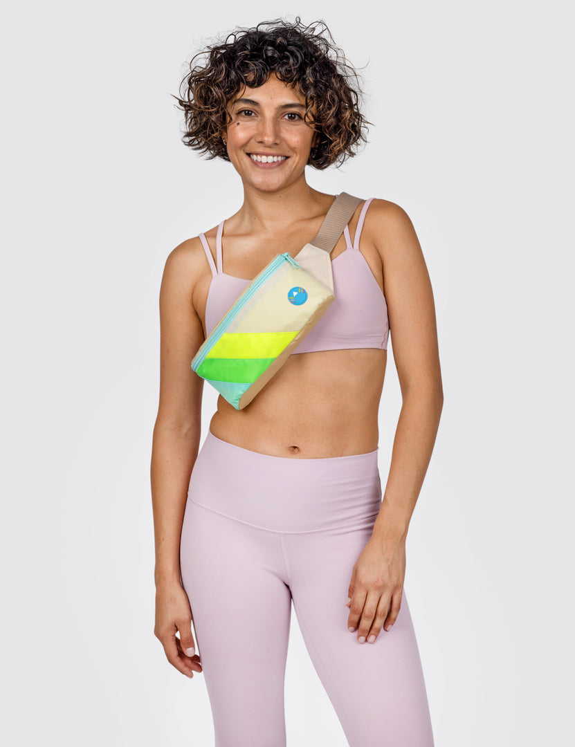Woman wearing neon Seas fanny pack