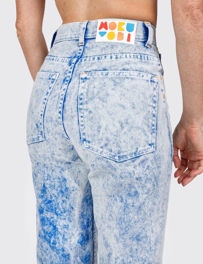 Back view of a woman wearing acid washed blue jeans