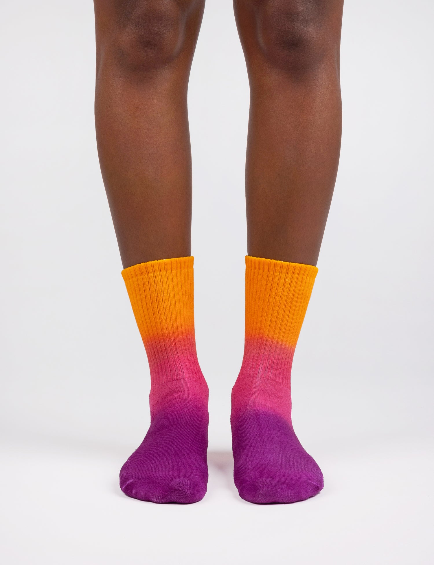 Image of feet wearing socks in gradient colors orange pink purple