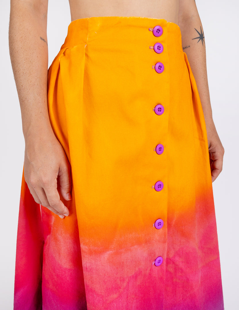 Woman wearing long sullivan skirt in gradient colors orange pink purple