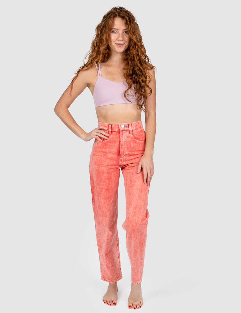 Woman wearing cherry color washed out jeans