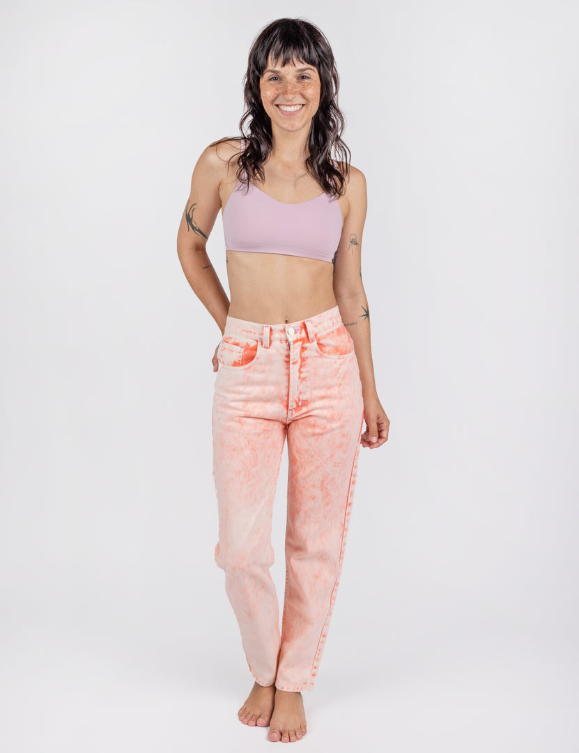 front of a woman in light pink jeans 
