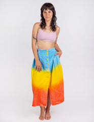 Woman wearing long sullivan skirt in gradient colors blue yellow orange