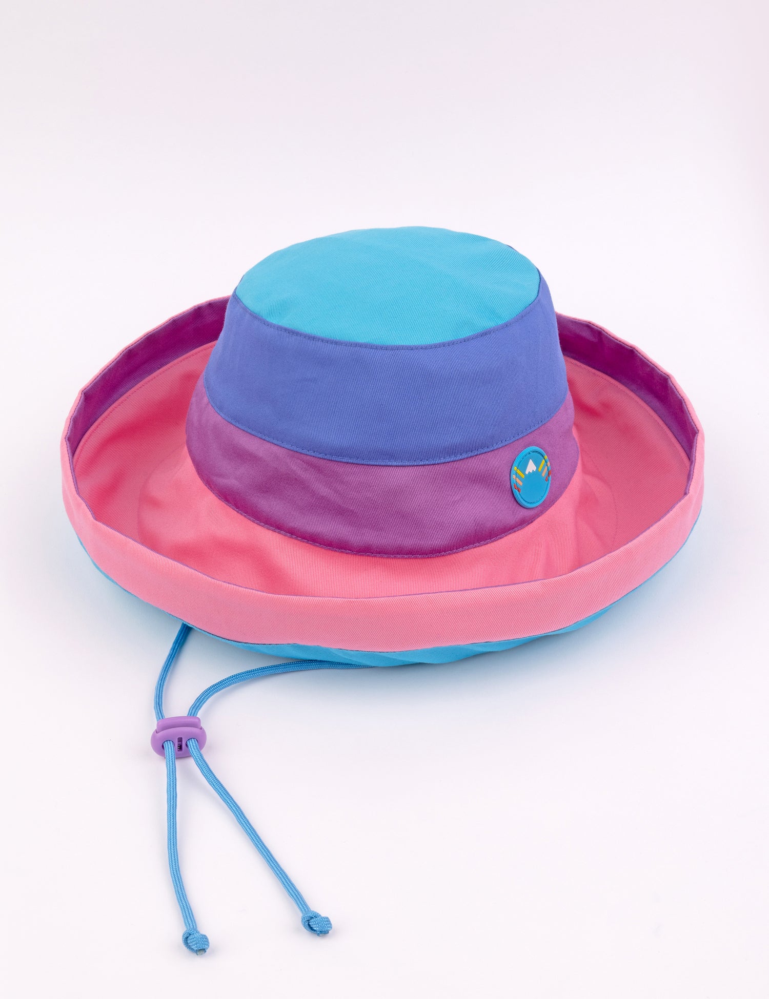 woman wearing a bucket style sunhat with blues and pinks.