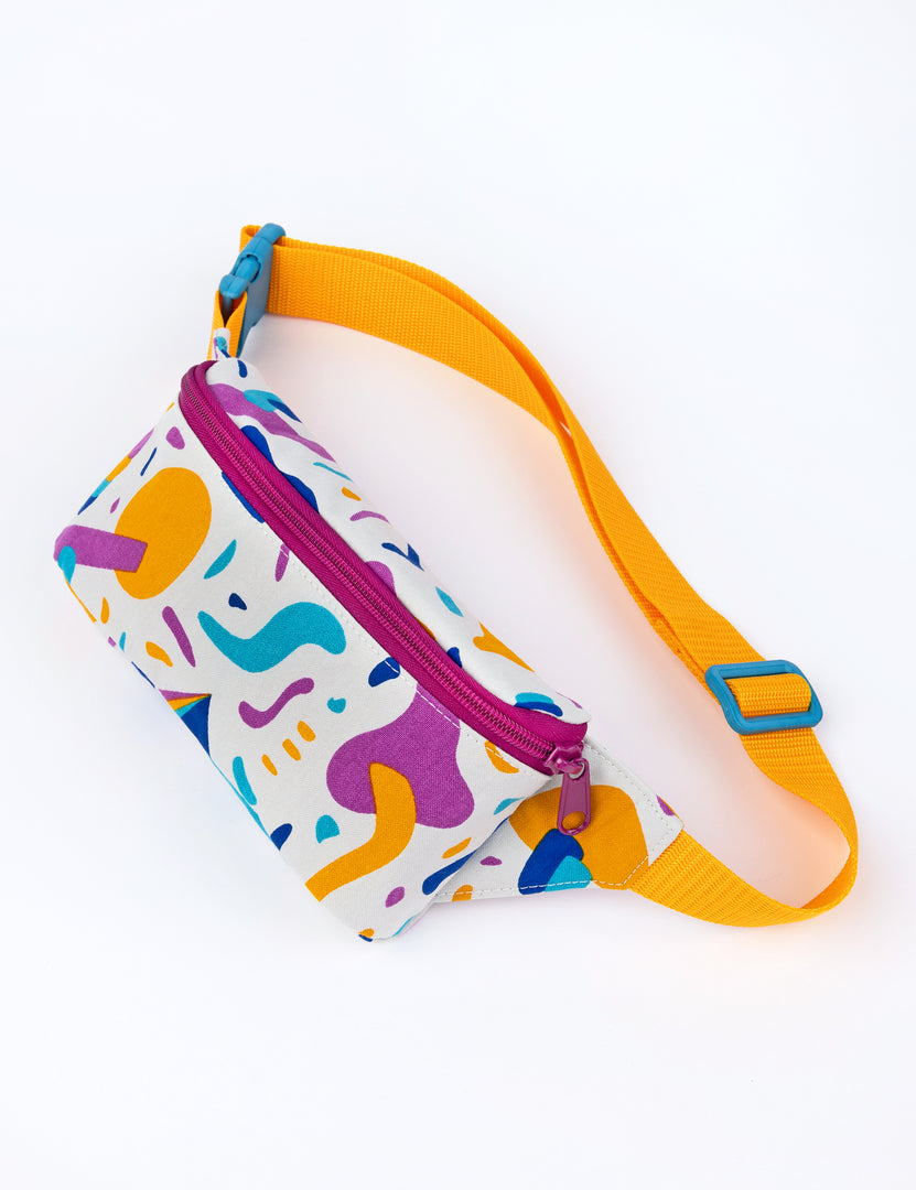 small whie fanny pack with colorful designs and saffron strap