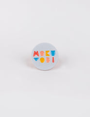 Picture of a enamel pin with the Mokuyobi logo