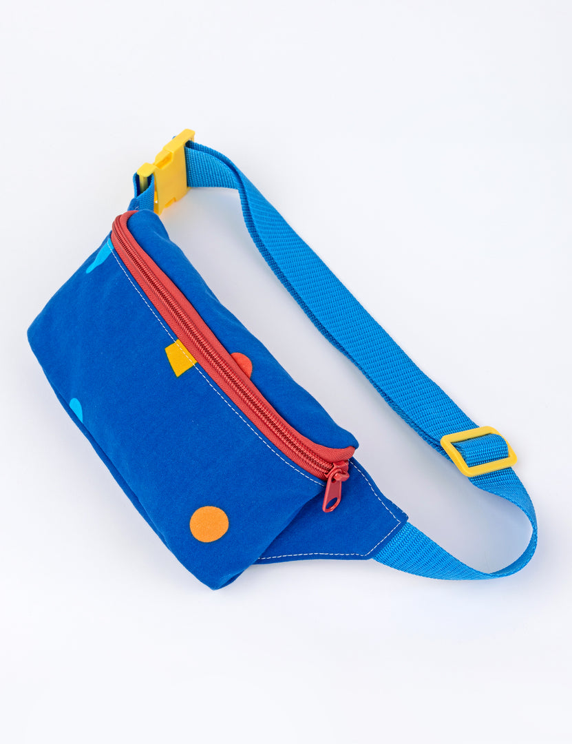 small dark blue fanny pack with small colorful designs and blue strap