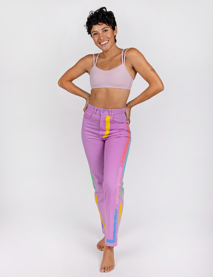 Woman wearing lavender jeans with neon lines design