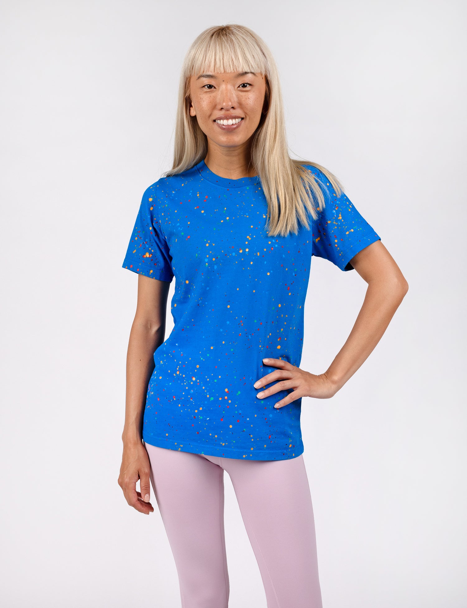 woman wearing a dark blue shirt with confetti paint all over