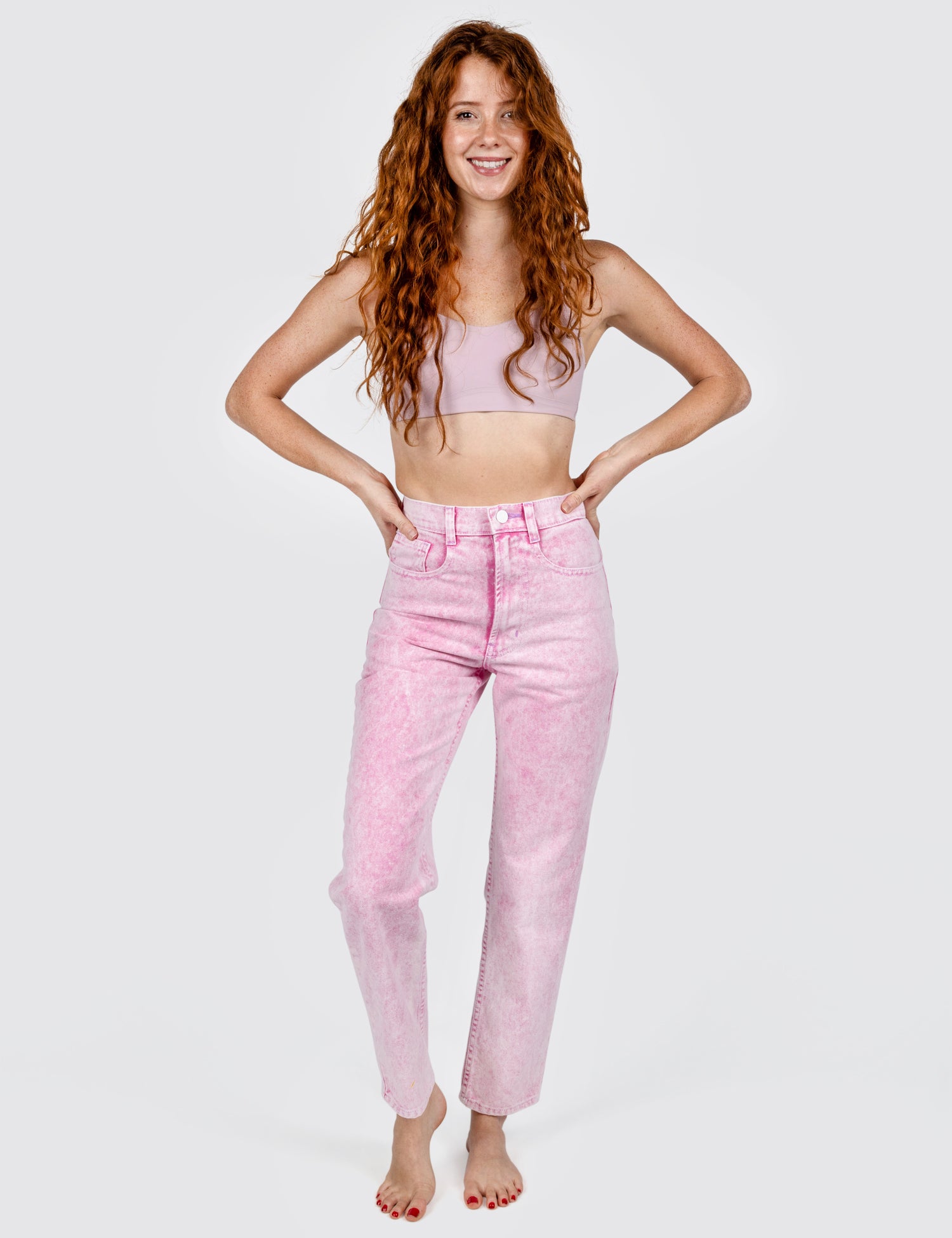 Woman wearing light pink washed out jeans
