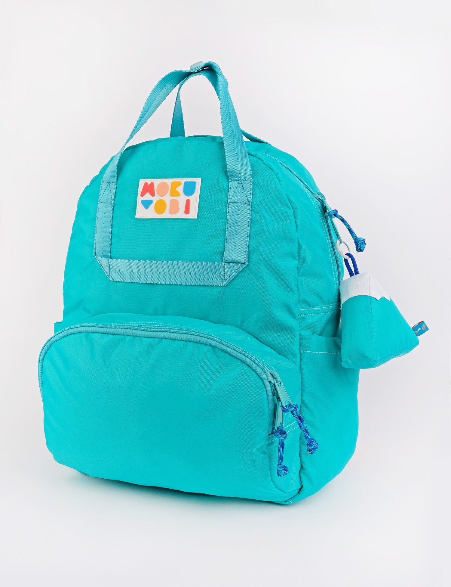 A Seafoam blue colored backpack with a keychain accessory