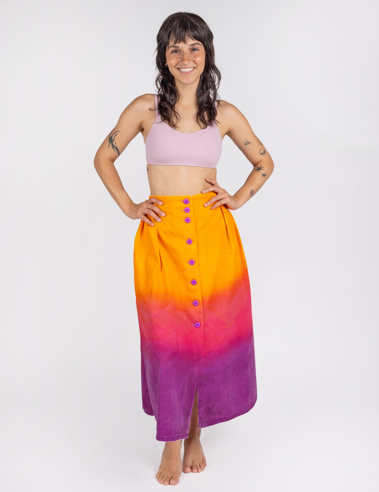 Woman wearing long sullivan skirt in gradient colors orange pink purple