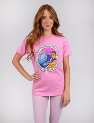 woman wearing pink shirt with circular design in the middle.
