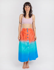 Woman wearing long sullivan skirt in gradient colors red aqua blue