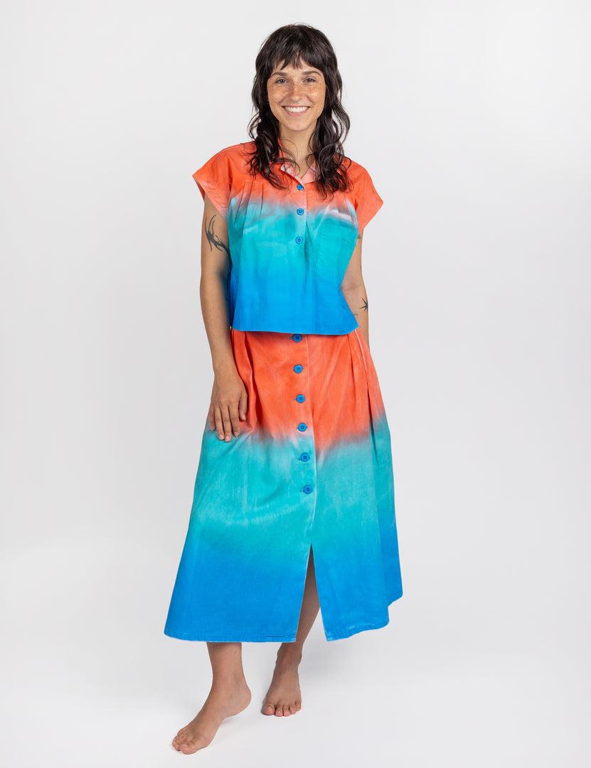 Woman wearing long sullivan skirt in gradient colors red aqua blue