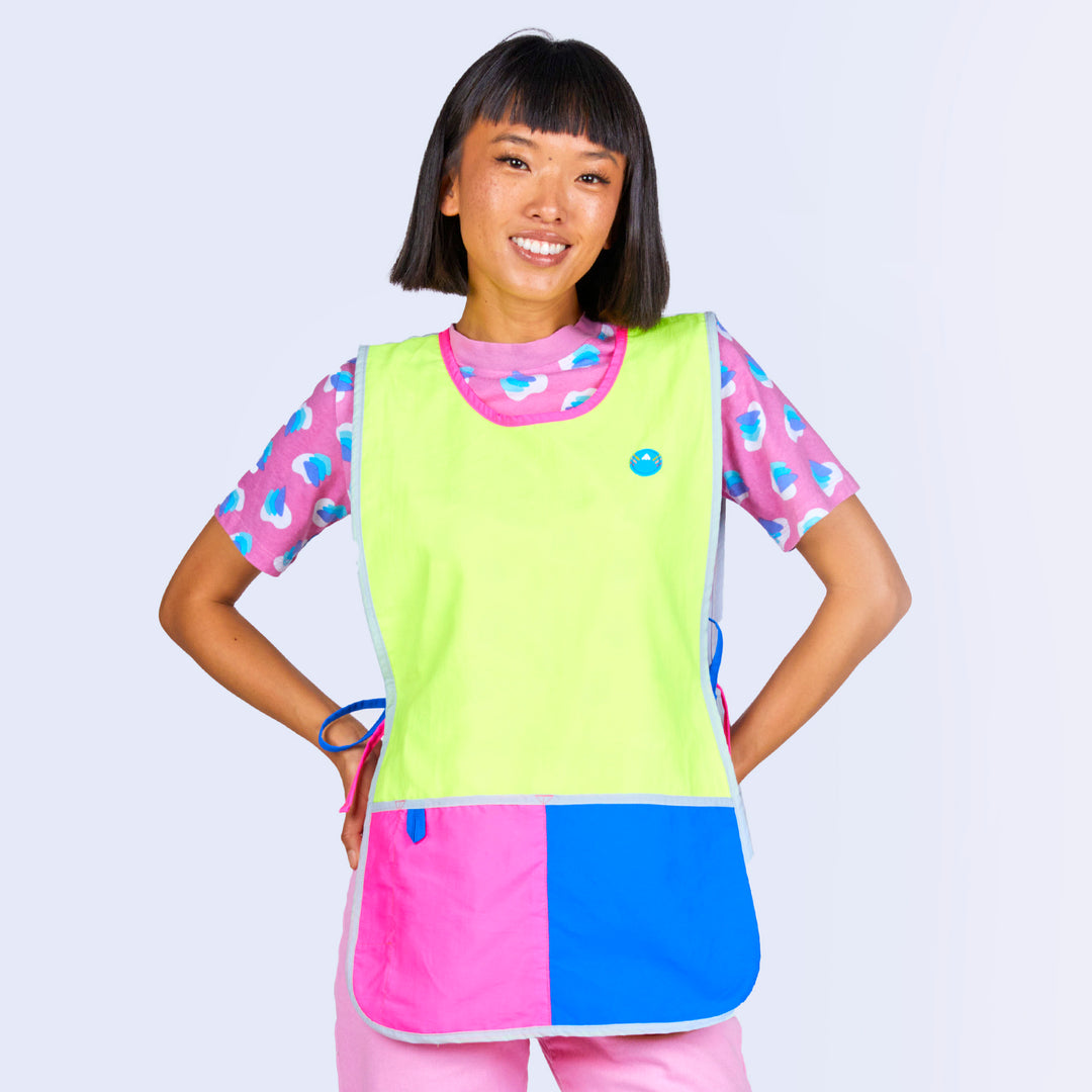 A woman wearing a color block apron