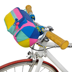 A colorful bike bag perched on bike handle bars