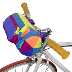 A colorful bike bag perched on bike handle bars