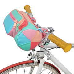 A colorful bike bag perched on bike handle bars